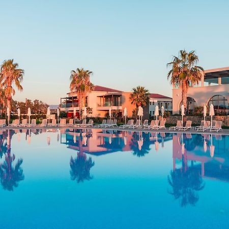 Almyros Beach Almiros Beach Bagian luar foto The resort at sunset